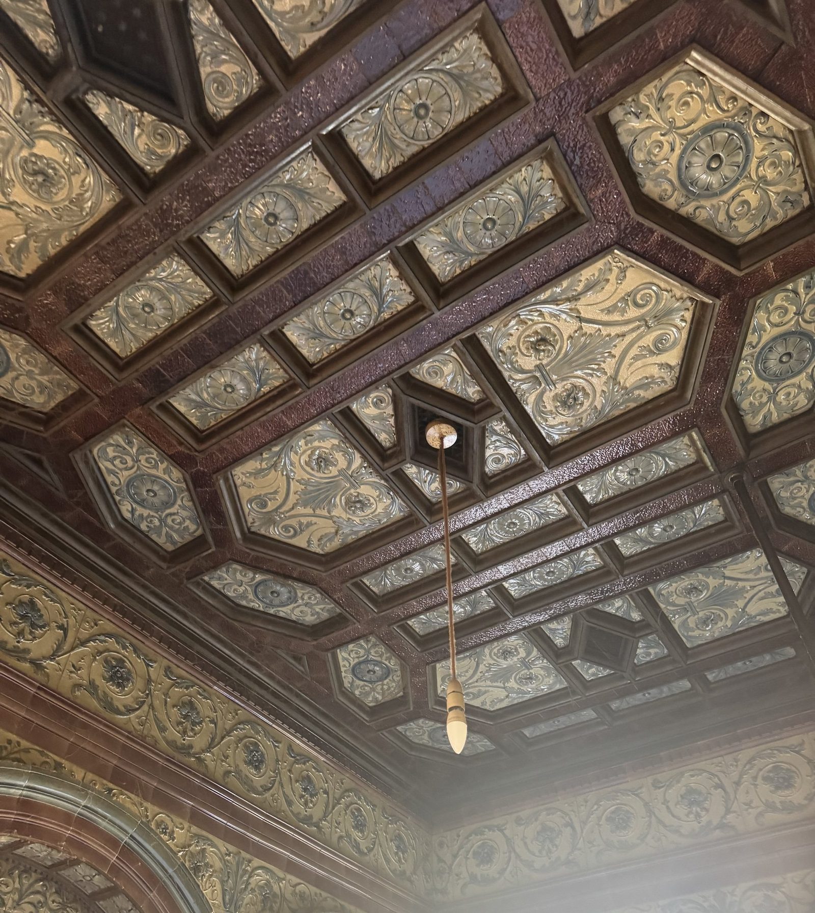 A coffered ceiling finished entirely in patterned glazed tiles, photographed on a viewing.